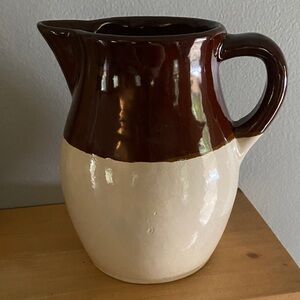 A Roseville R.R.P. Co. stoneware pitcher with brown and tan glaze.